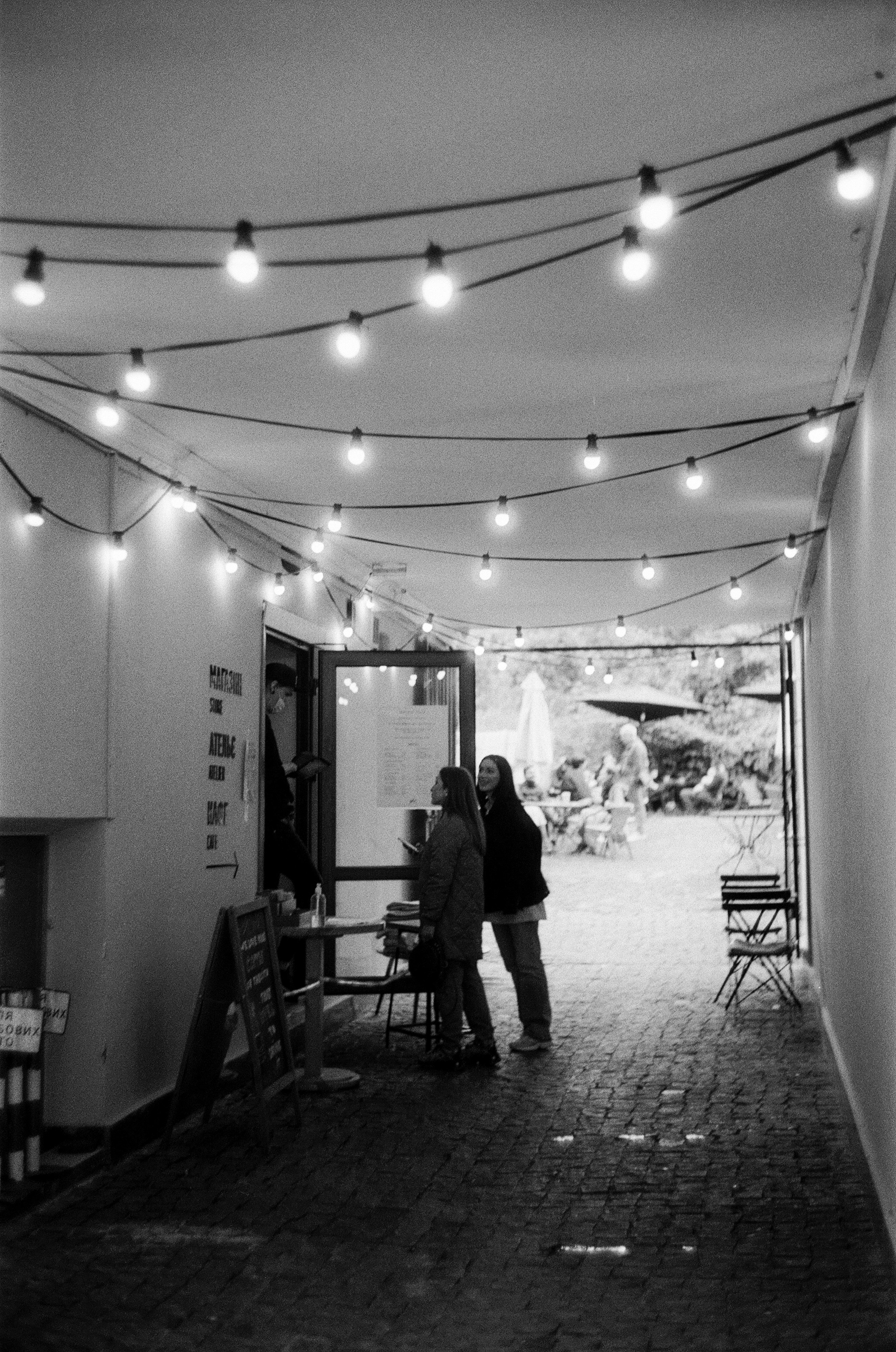 grayscale photo of people in restaurant